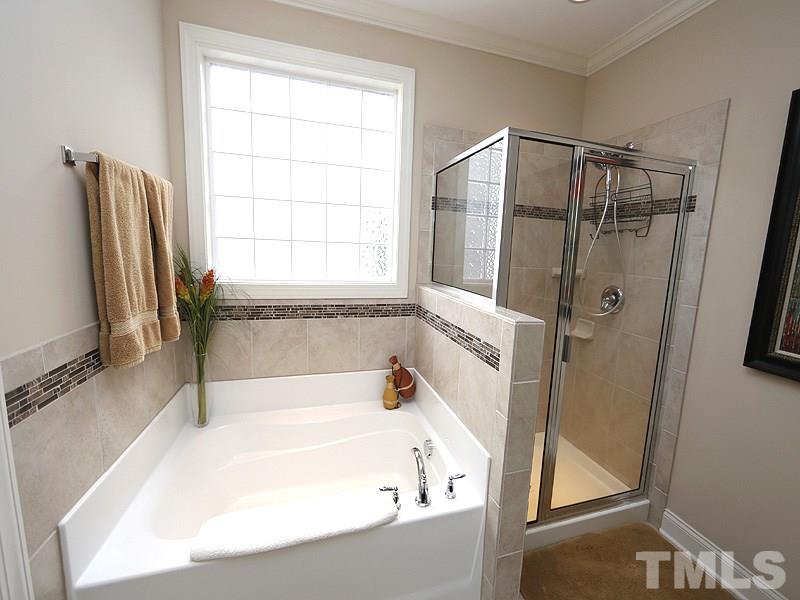 1145 Chapanoke Road Raleigh, NC 27603 - Photo 16 of 25 Tile accents the walk-in shower and the tub surround. There is a separate commode room.
