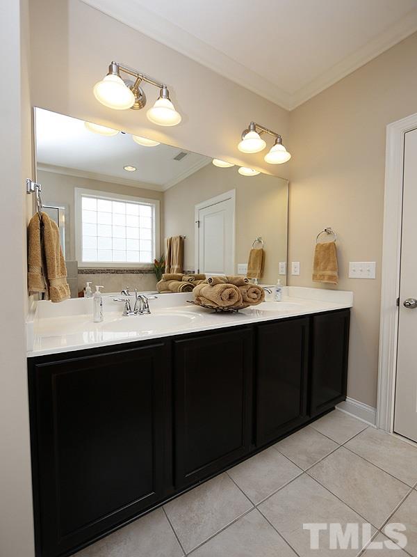 1145 Chapanoke Road Raleigh, NC 27603 - Photo 17 of 25 A large vanity with 2 sinks offers space for more than one to get ready.