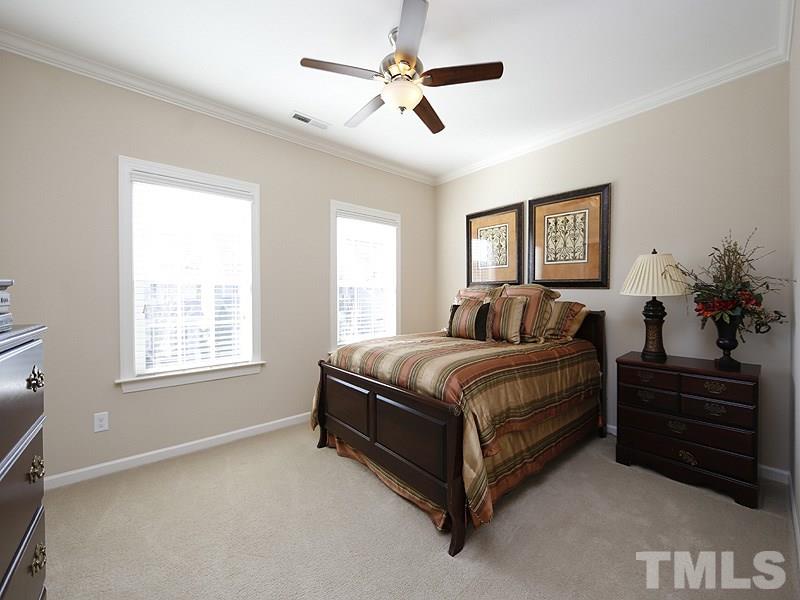 1145 Chapanoke Road Raleigh, NC 27603 - Photo 20 of 25 One of the upstairs bedrooms. They are both large and have fans, walk-in closets and crown molding.