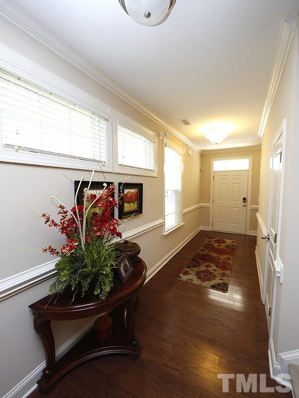 1145 Chapanoke Road Raleigh, NC 27603 - Photo 4 of 25 The light-filled foyer offers a pathway to the main living area. Notice the crown and chair moldings.