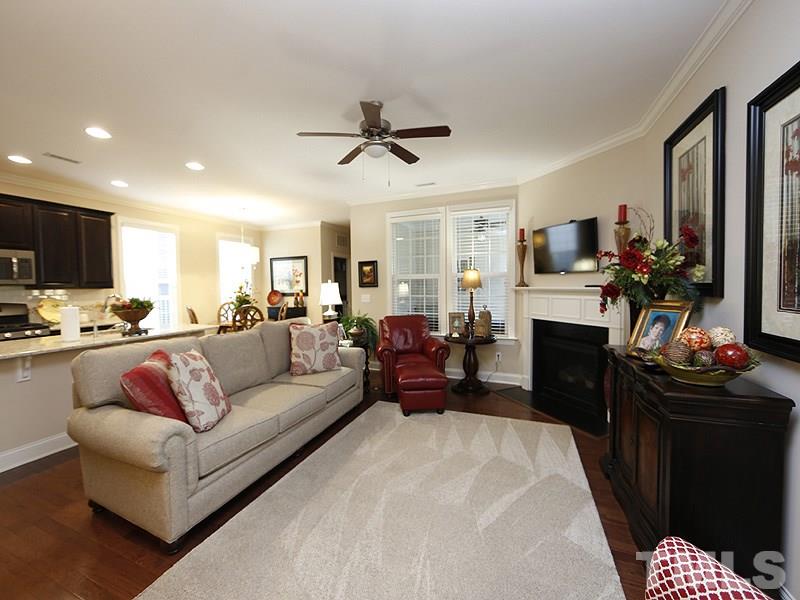 1145 Chapanoke Road Raleigh, NC 27603 - Photo 5 of 25 The living room/kitchen/dining are all open to each other-fabulous for entertaining. There is a corner, gas fireplace with slate surround. Hardwoods grace the main floor living areas (except for master suite). There is a ceiling fan in the living room.