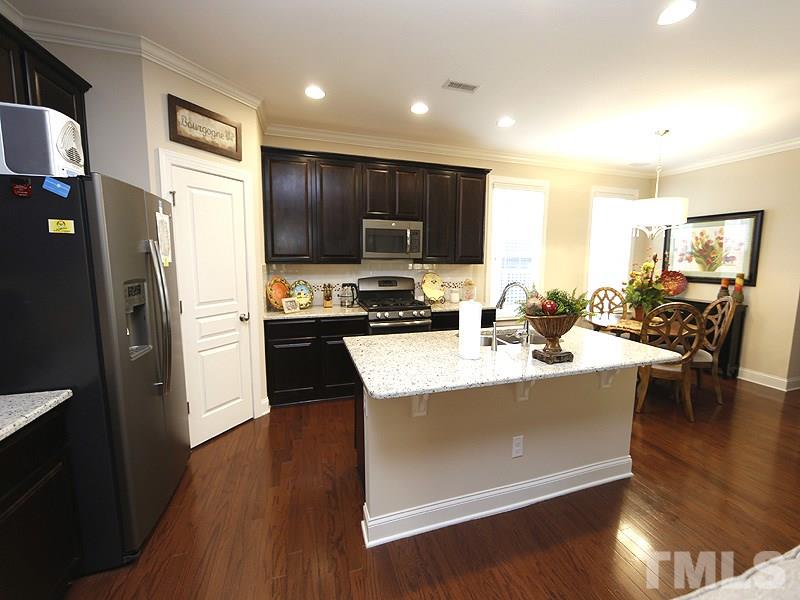 1145 Chapanoke Road Raleigh, NC 27603 - Photo 10 of 25 There is a corner, walk-in pantry. Have a seat at the island or dine in the dining area to the right of the kitchen.