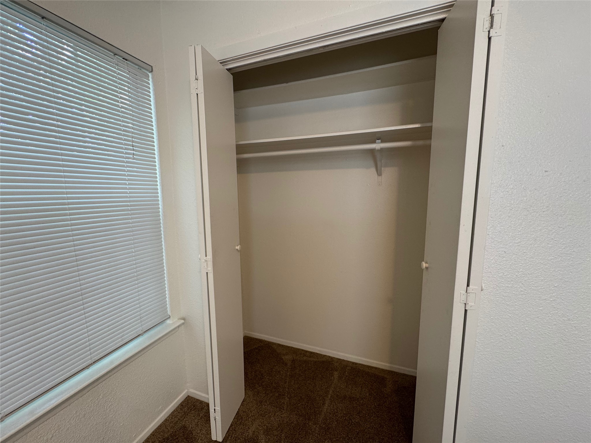 4810 West Wind Trail, Unit 102 Austin, TX 78745 - Photo 15 of 23 a view of walk in closet with empty racks