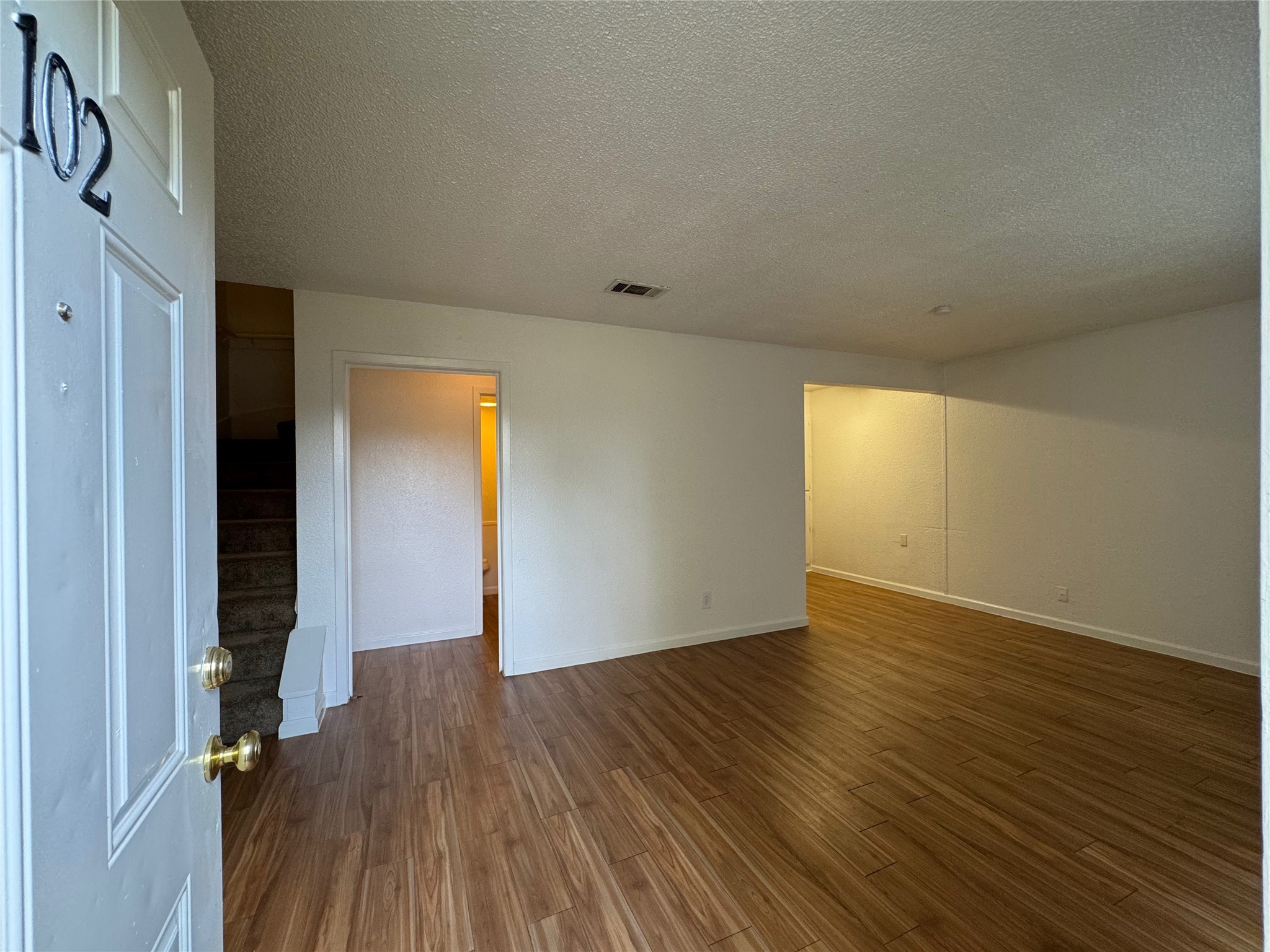 4810 West Wind Trail, Unit 102 Austin, TX 78745 - Photo 2 of 23 wooden floor in an empty room