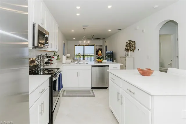 a kitchen with a sink appliances and cabinets