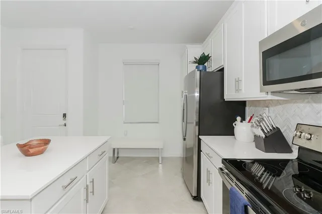 a kitchen with a sink and a stove top oven