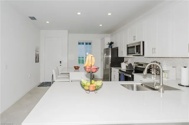 a view of a living room a dining table and a couch