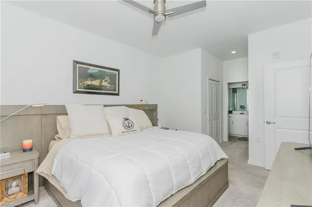 a bedroom with a bed and a painting on the wall