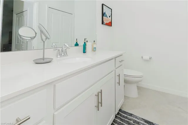 a bathroom with a sink a toilet and mirror