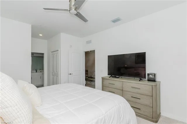 a bedroom with a flat screen tv and bed