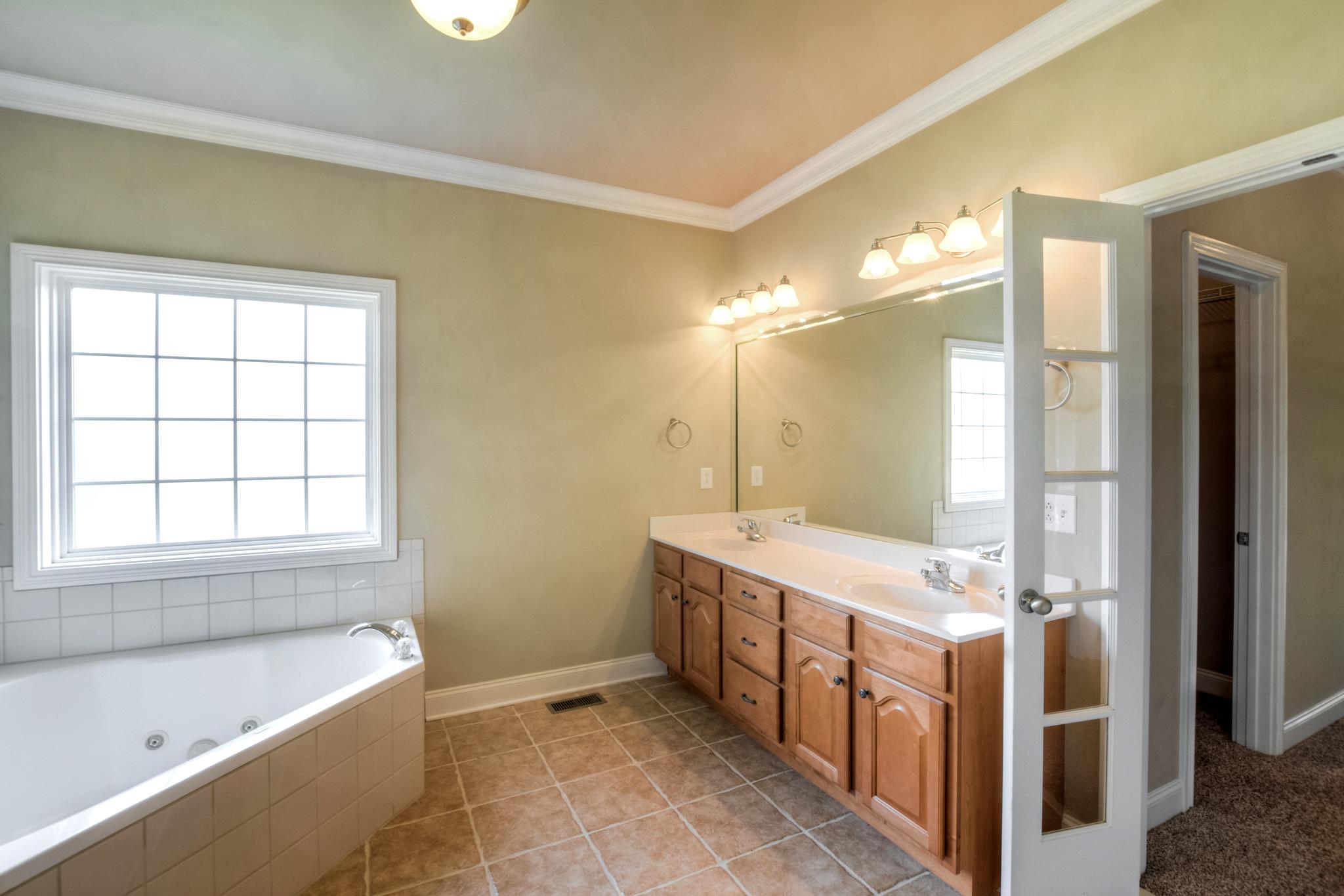 3914 Rowland Road Murfreesboro, TN 37128 - Photo 15 of 29 a bathroom with a tub sink and mirror