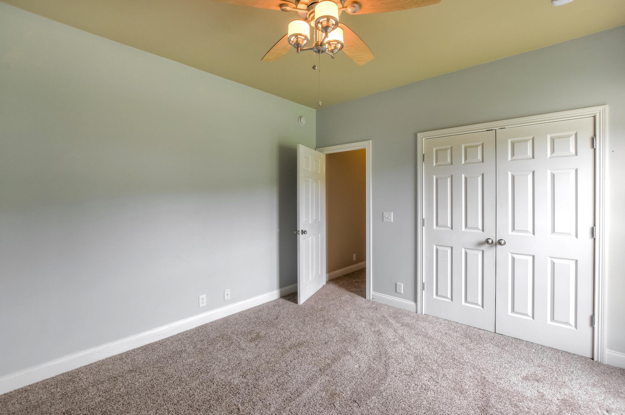 3914 Rowland Road Murfreesboro, TN 37128 - Photo 18 of 29 an empty room with a chandelier fan and closet area