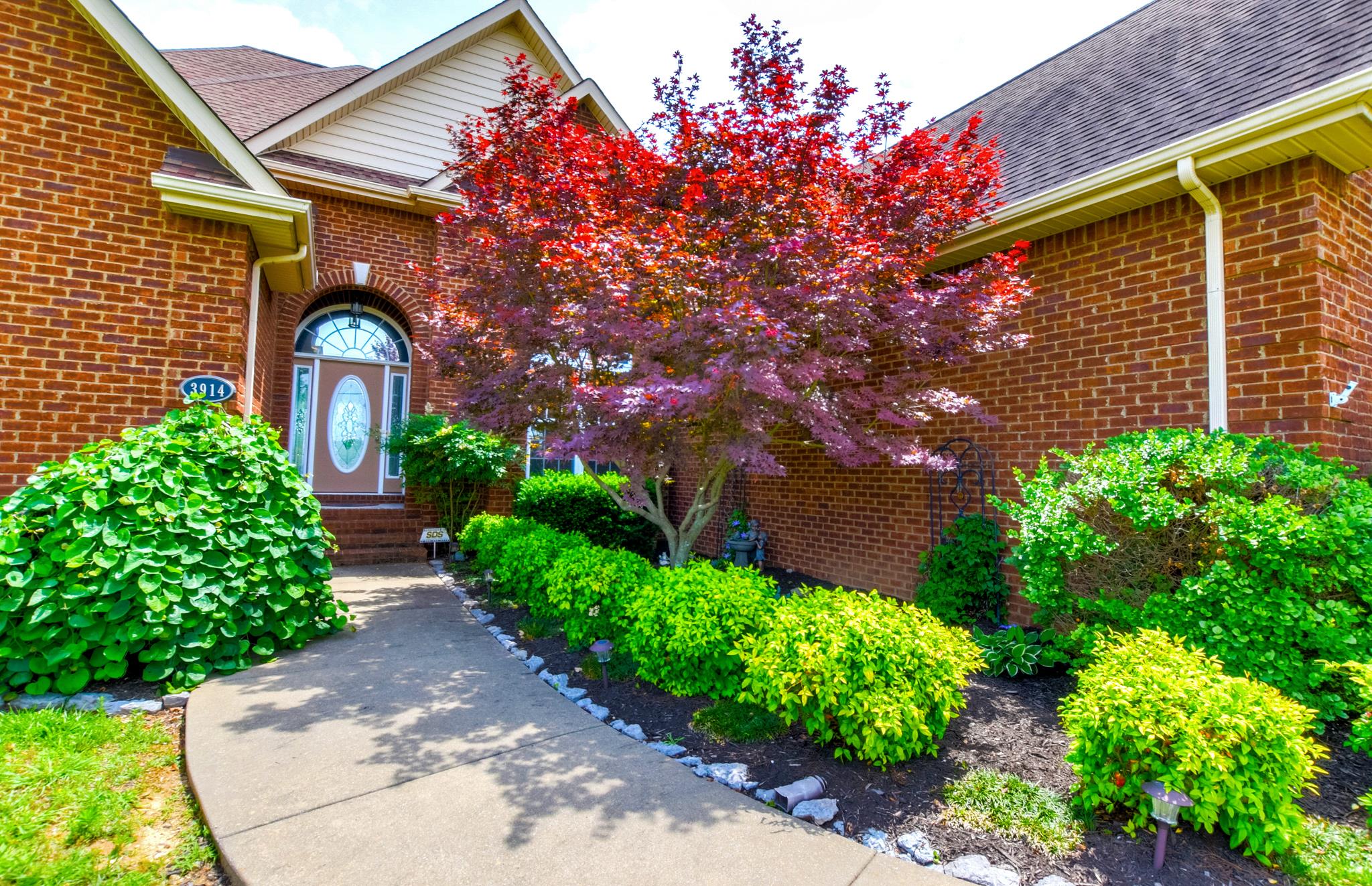 3914 Rowland Road Murfreesboro, TN 37128 - Photo 2 of 29 a front view of a house with a yard garage and outdoor seating
