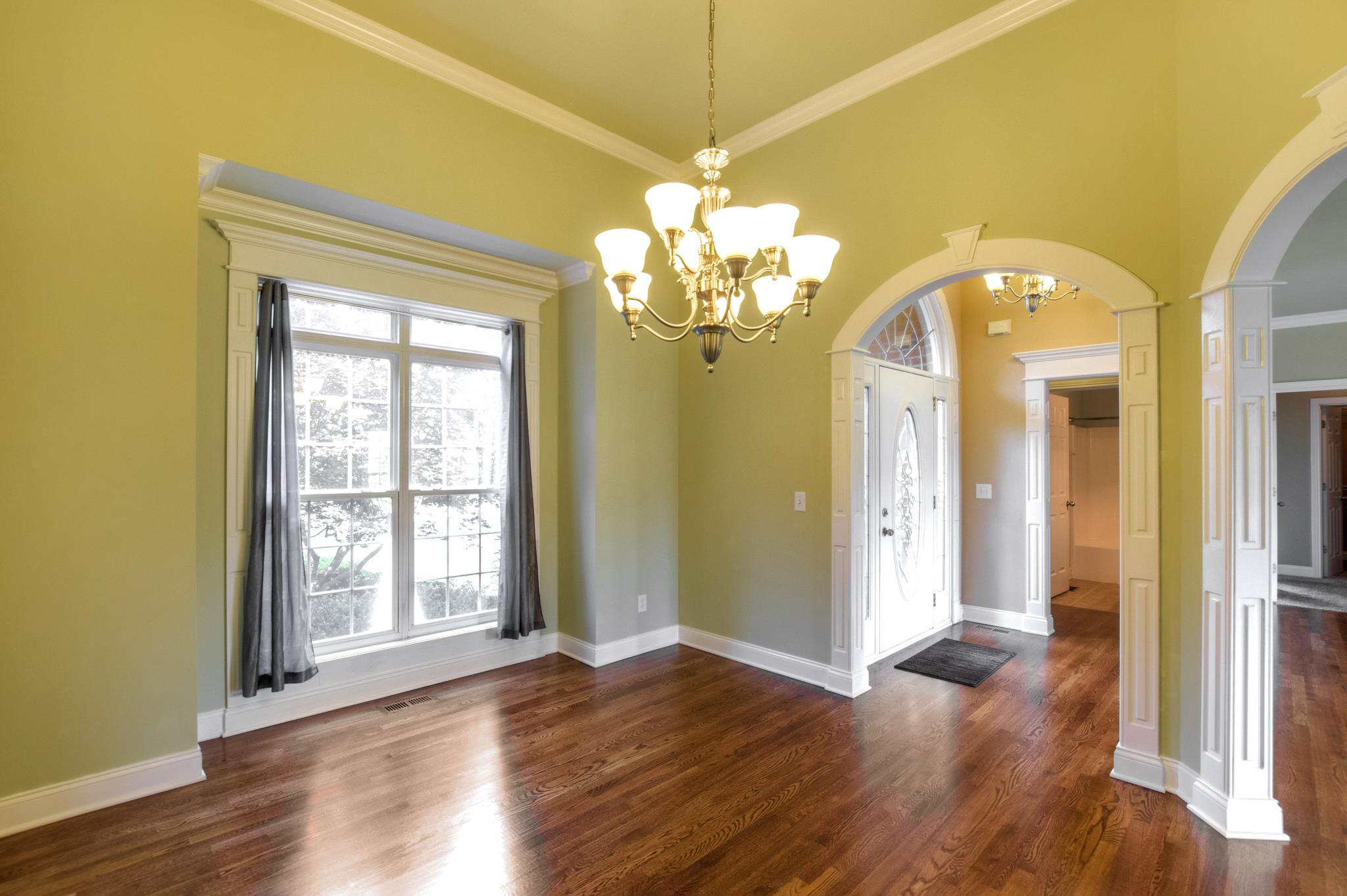 3914 Rowland Road Murfreesboro, TN 37128 - Photo 7 of 29 a view of a hallway with wooden floor and a chandelier