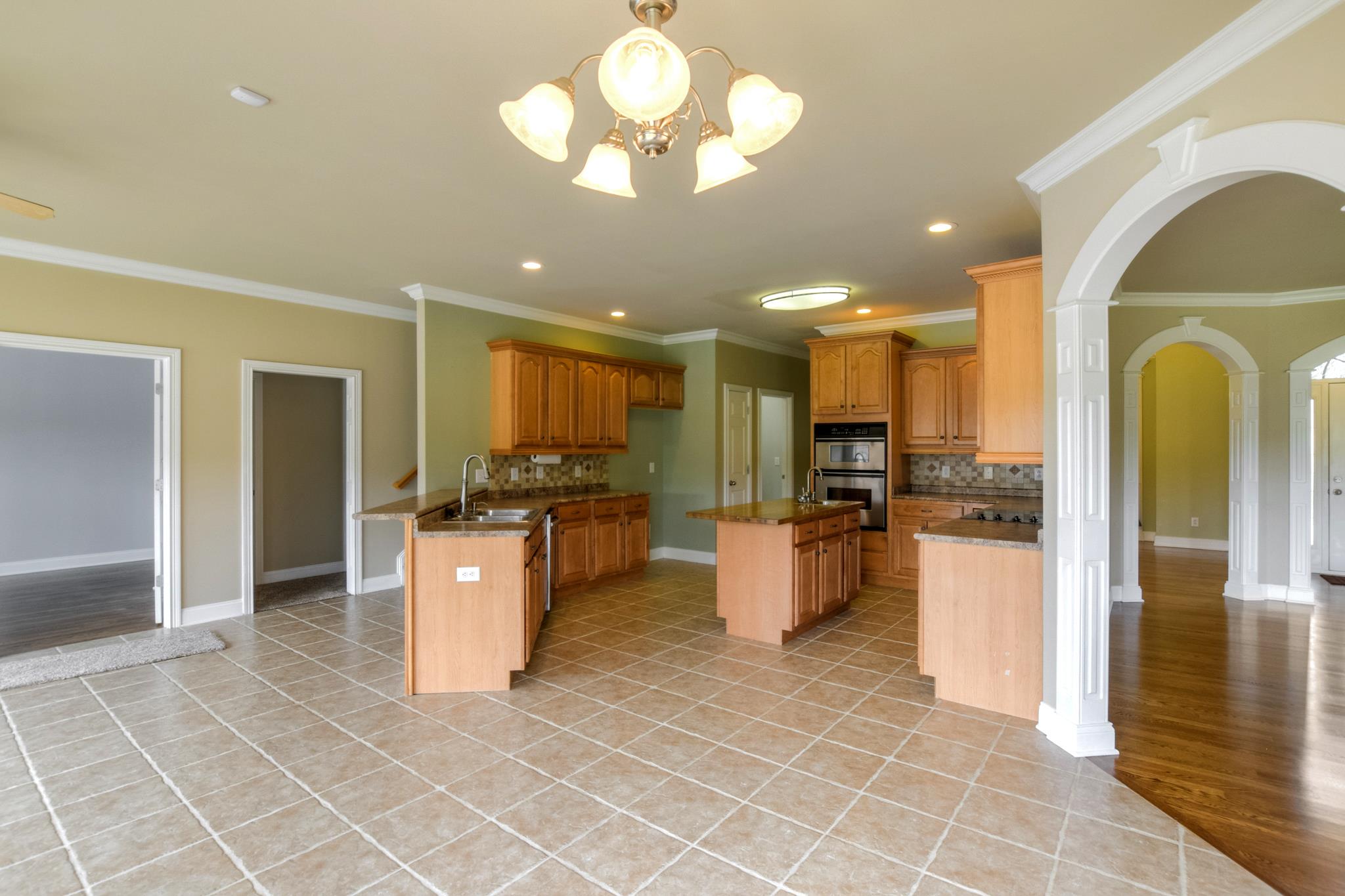 3914 Rowland Road Murfreesboro, TN 37128 - Photo 8 of 29 a large kitchen with a large counter top stainless steel appliances and cabinets