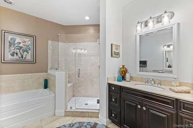 a bathroom with a tub sink and mirror