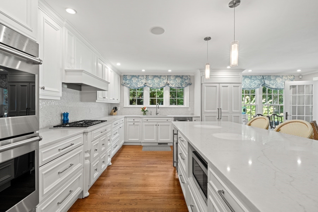 193 Winding River Road Wellesley, MA 02482 - Photo 11 of 42 a kitchen with stainless steel appliances granite countertop a sink a stove and a wooden floors