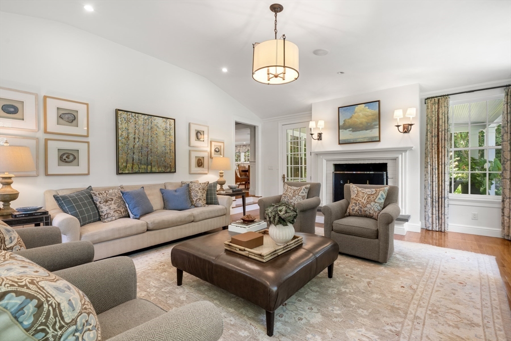 193 Winding River Road Wellesley, MA 02482 - Photo 14 of 42 a living room with furniture a table and a fireplace