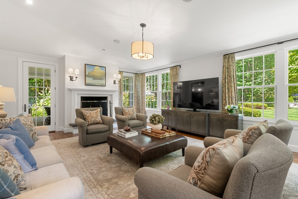 193 Winding River Road Wellesley, MA 02482 - Photo 16 of 42 a living room with furniture fireplace and a large window