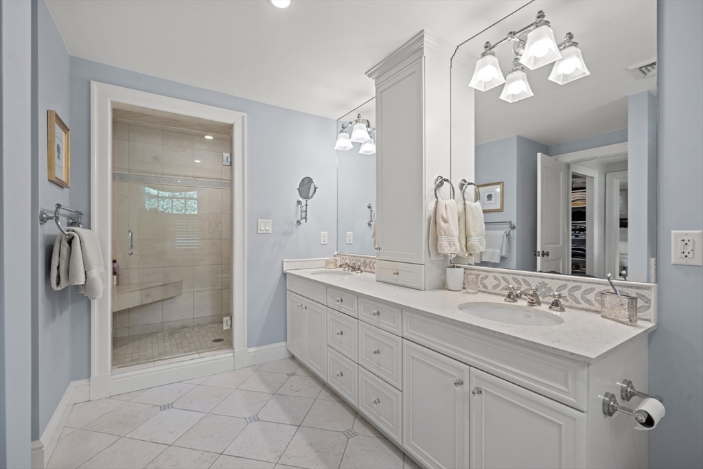 193 Winding River Road Wellesley, MA 02482 - Photo 25 of 42 a bathroom with a double vanity sink mirror and shower
