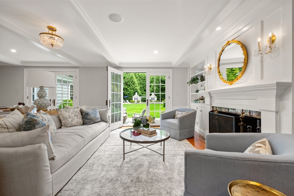 193 Winding River Road Wellesley, MA 02482 - Photo 3 of 42 a living room with furniture and a fireplace