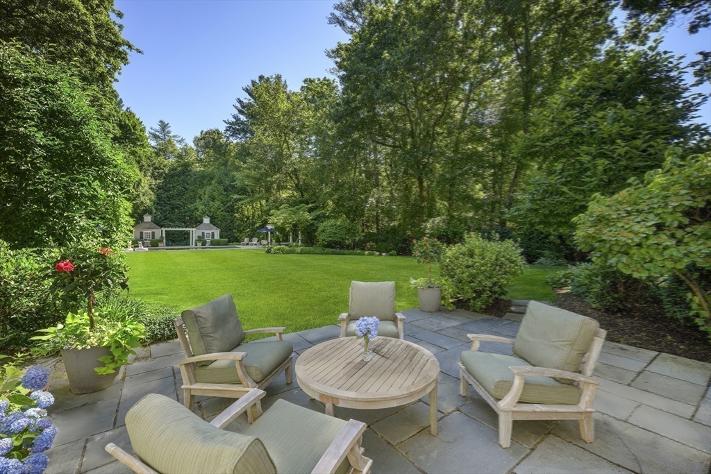 193 Winding River Road Wellesley, MA 02482 - Photo 35 of 42 a view of a patio with a chairs and a table