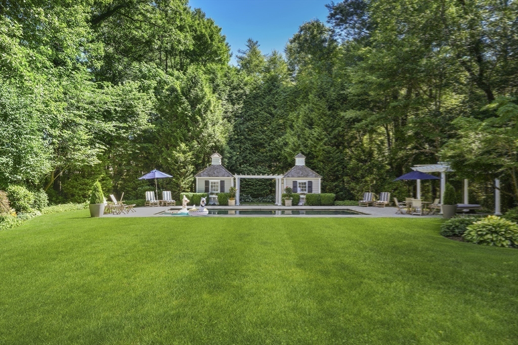 193 Winding River Road Wellesley, MA 02482 - Photo 36 of 42 a front view of a house with a yard table and chairs