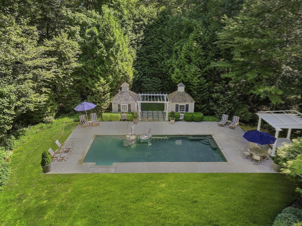 193 Winding River Road Wellesley, MA 02482 - Photo 39 of 42 a view of house with swimming pool outdoor seating and trees