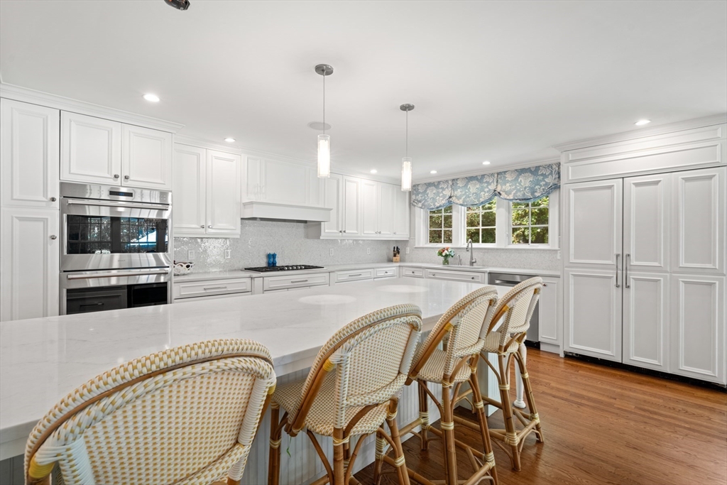 193 Winding River Road Wellesley, MA 02482 - Photo 9 of 42 a view of a kitchen with kitchen island granite countertop wooden floor stainless steel appliances and cabinets