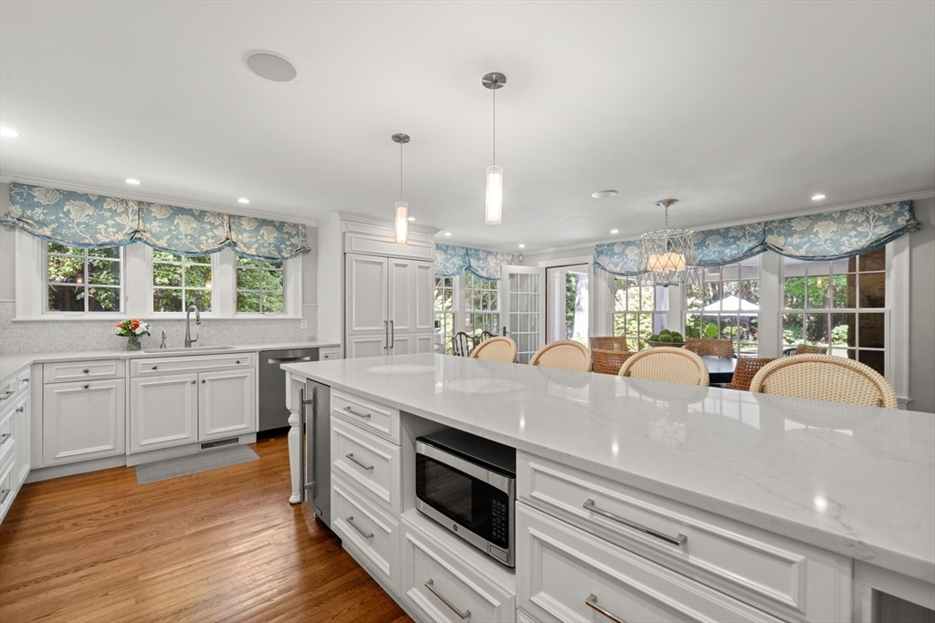 193 Winding River Road Wellesley, MA 02482 - Photo 10 of 42 a kitchen with kitchen island granite countertop a sink appliances and cabinets