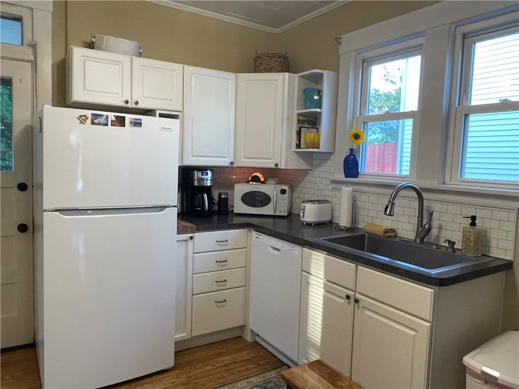33 Line Street Sharpsville, PA 16150 - Photo 11 of 34 a kitchen with refrigerator a sink and white cabinets