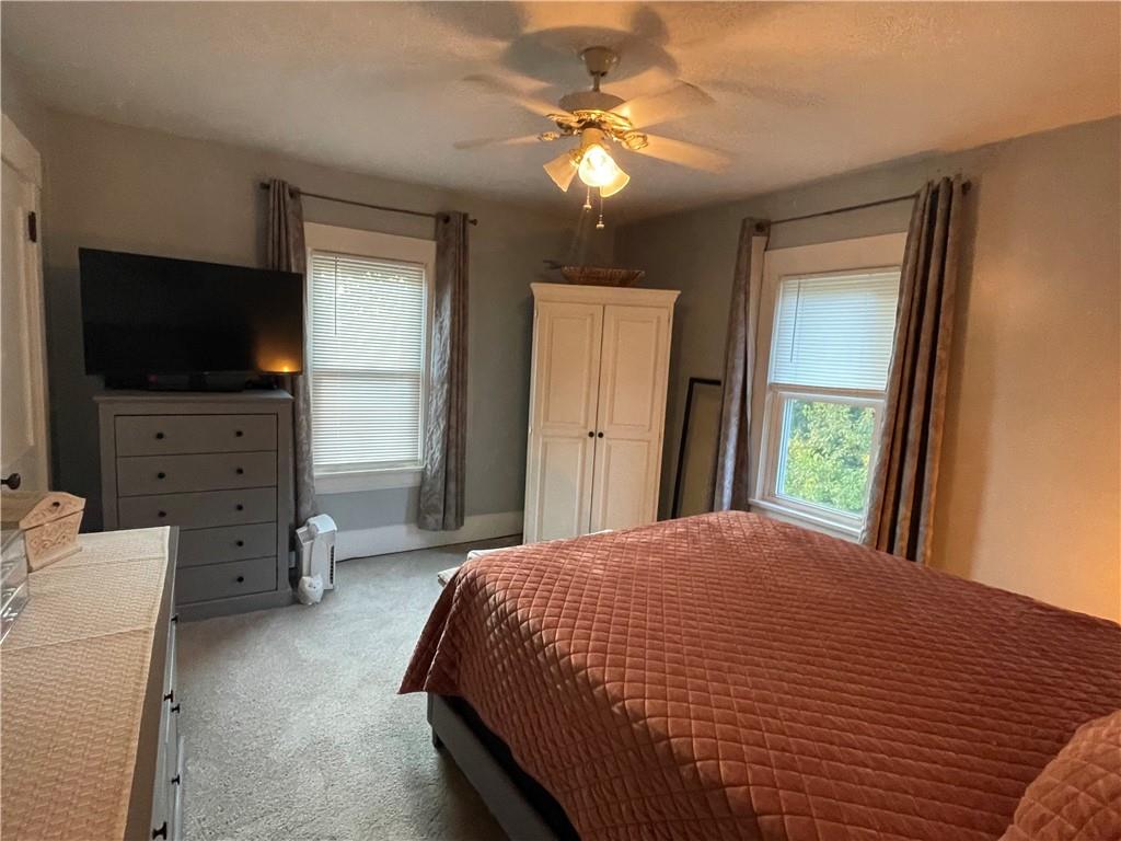 33 Line Street Sharpsville, PA 16150 - Photo 14 of 34 a spacious bedroom with a bed and a flat screen tv