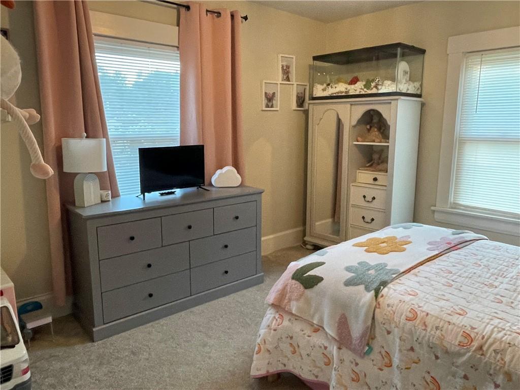 33 Line Street Sharpsville, PA 16150 - Photo 18 of 34 a bedroom with a bed and a flat tv screen on dresser