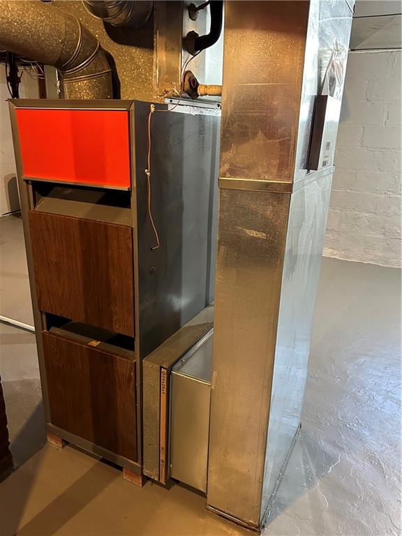33 Line Street Sharpsville, PA 16150 - Photo 24 of 34 a room with water heater and wooden cabinets