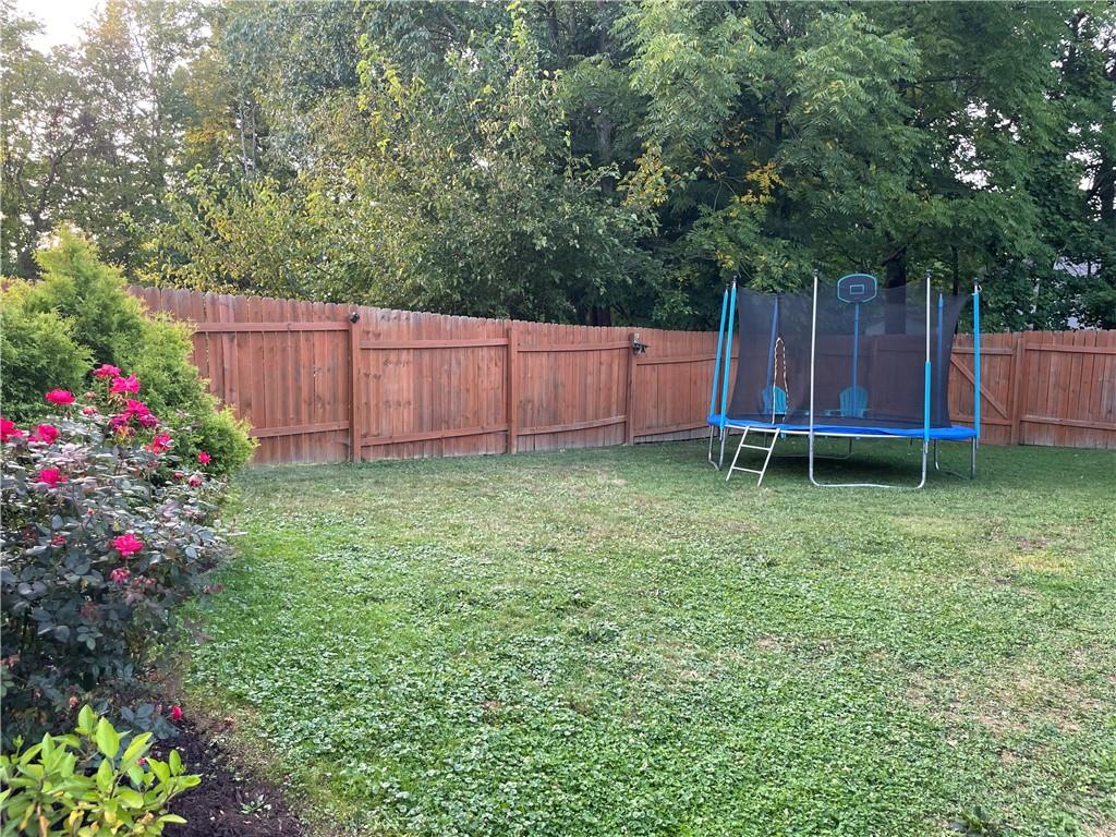 33 Line Street Sharpsville, PA 16150 - Photo 26 of 34 a view of a backyard with potted plants and wooden fence