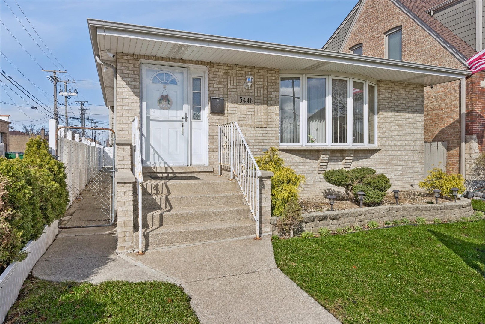 a front view of a house with a garden