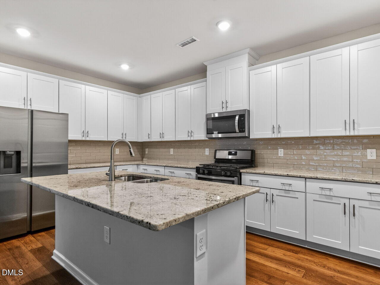 67 Coffee Tree Circle Clayton, NC 27527 - Photo 11 of 34 a kitchen with granite countertop a sink stove and refrigerator