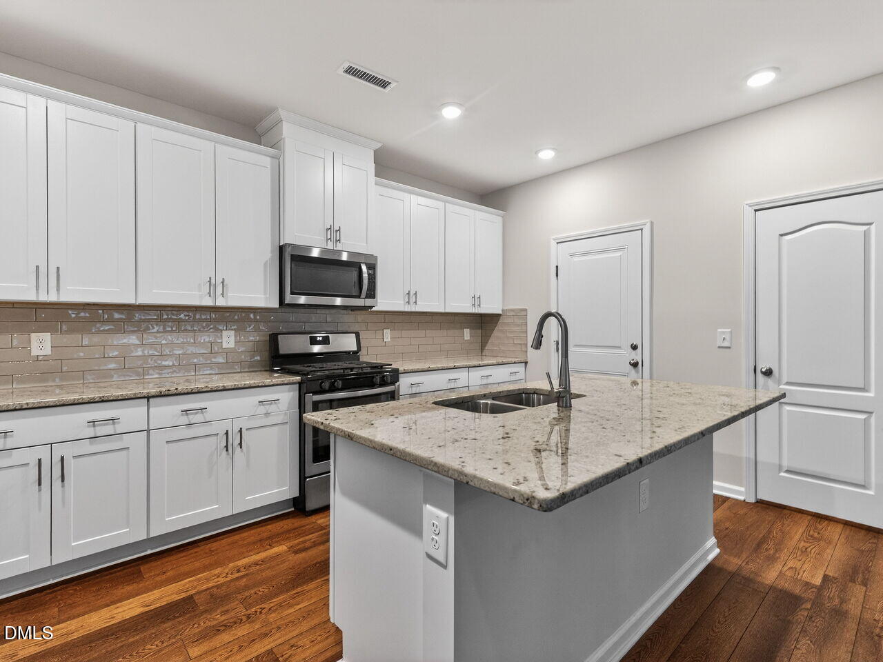 67 Coffee Tree Circle Clayton, NC 27527 - Photo 12 of 34 a kitchen with granite countertop white cabinets and a granite counter tops