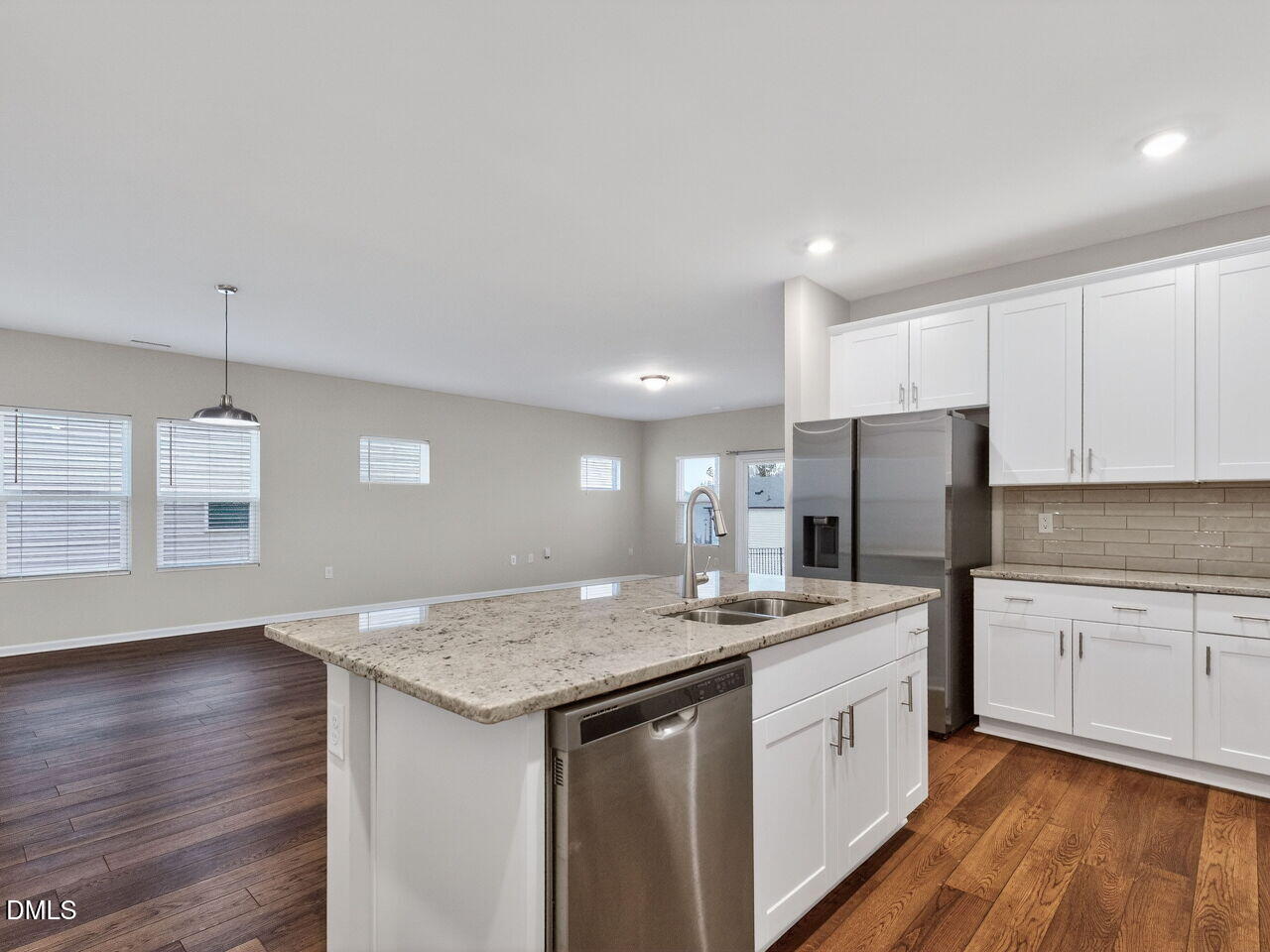 67 Coffee Tree Circle Clayton, NC 27527 - Photo 13 of 34 a kitchen with a sink a refrigerator and white cabinets
