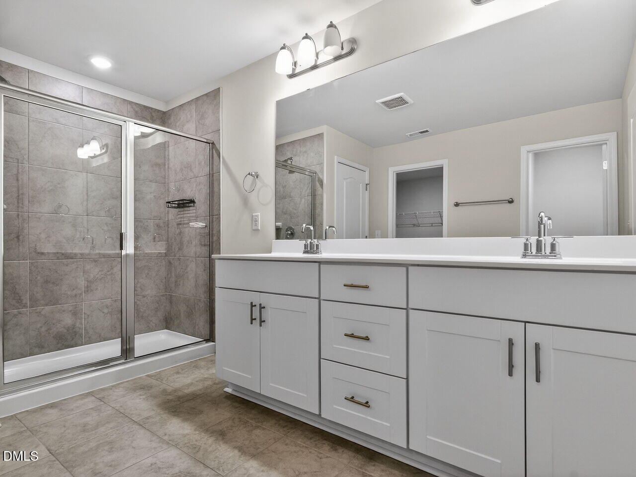 67 Coffee Tree Circle Clayton, NC 27527 - Photo 23 of 34 a bathroom with a double vanity sink mirror and shower
