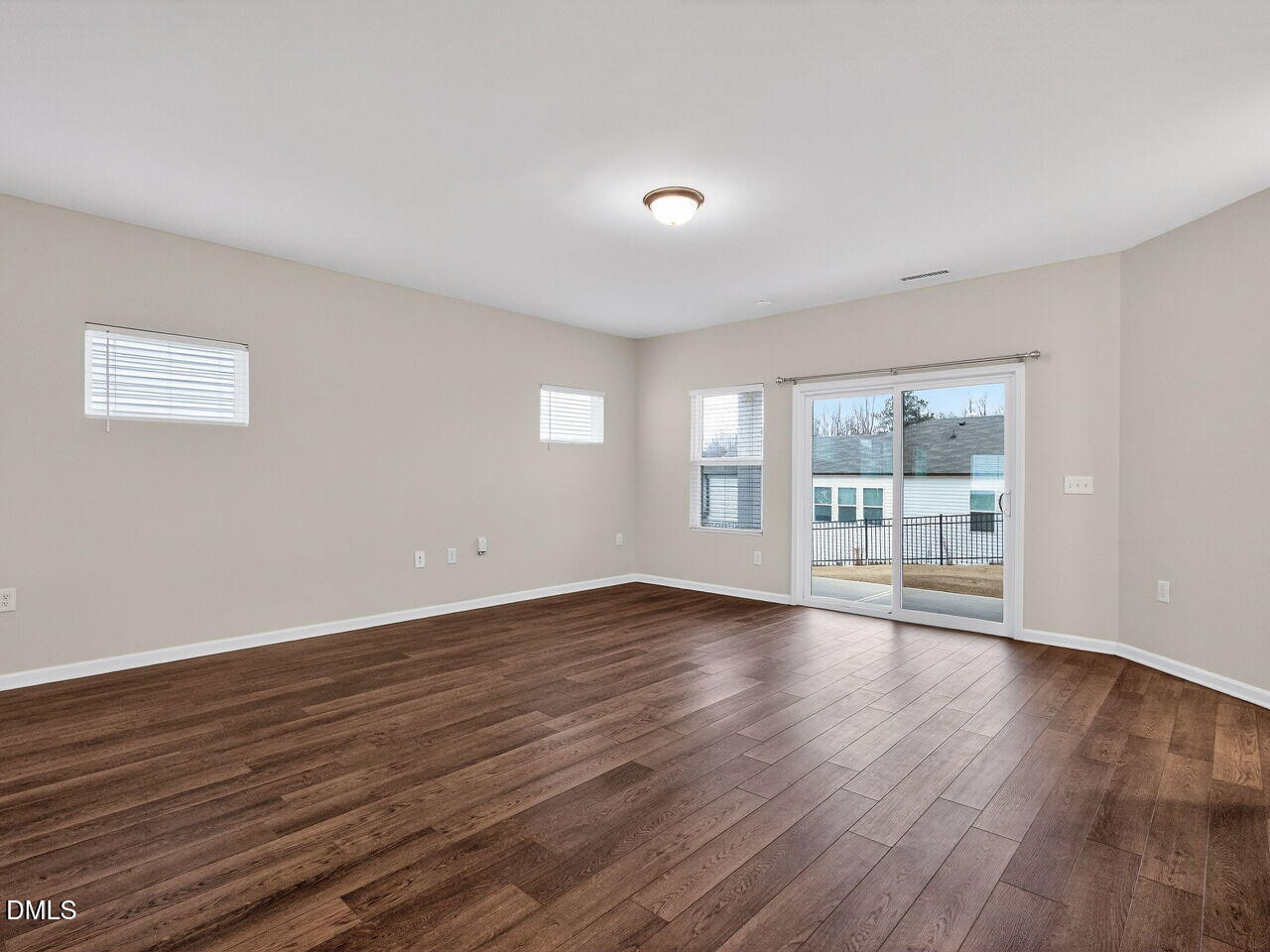 67 Coffee Tree Circle Clayton, NC 27527 - Photo 6 of 34 a view of an empty room with wooden floor and a window