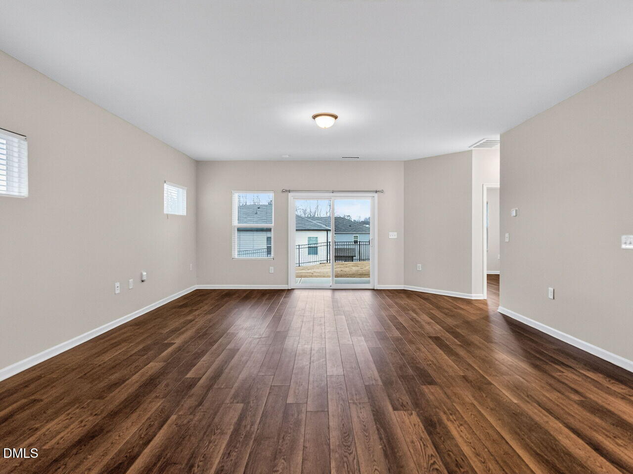 67 Coffee Tree Circle Clayton, NC 27527 - Photo 7 of 34 a view of an empty room with wooden floor and a window