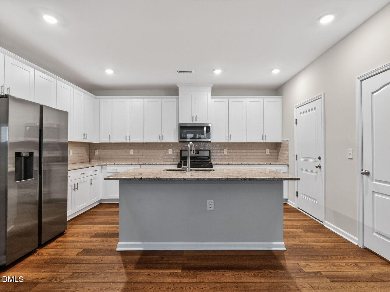 67 Coffee Tree Circle Clayton, NC 27527 - Photo 10 of 34 a kitchen with stainless steel appliances granite countertop a stove a sink and a refrigerator