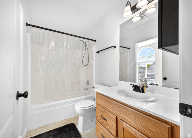 802 Sugar Maple Court Payson, UT 84651 - Photo 17 of 30 Bathroom featuring vanity, shower / tub combo with curtain, and light tile patterned floors