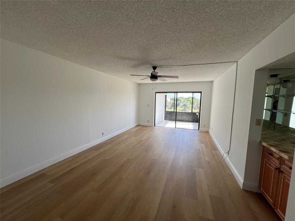 9300 Southwest 8th Street, Unit 422 Boca Raton, FL 33428 - Photo 15 of 38 wooden floor in an empty room with a window