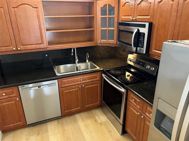 a bathroom with a tub sink and mirror