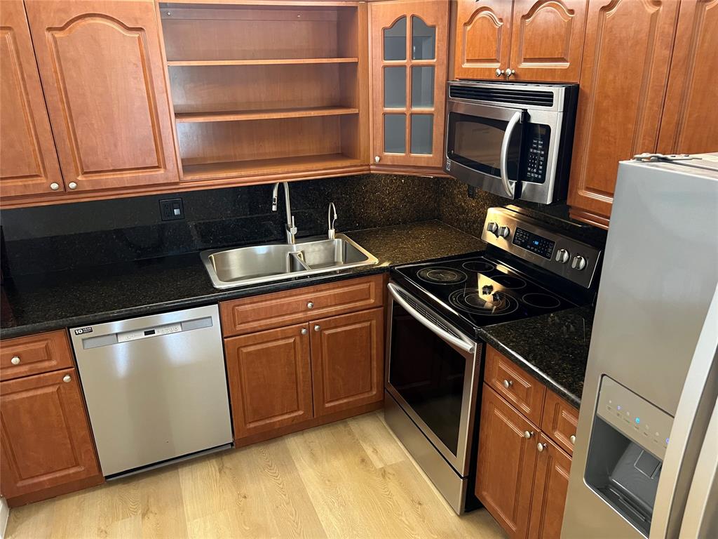 9300 Southwest 8th Street, Unit 422 Boca Raton, FL 33428 - Photo 17 of 38 a kitchen with granite countertop a stove and a refrigerator