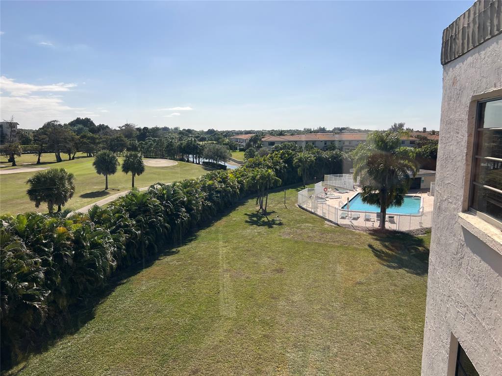 9300 Southwest 8th Street, Unit 422 Boca Raton, FL 33428 - Photo 18 of 38 a view of a lake with a mountain in the background
