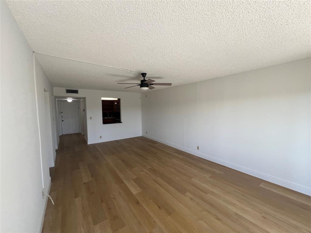 9300 Southwest 8th Street, Unit 422 Boca Raton, FL 33428 - Photo 19 of 38 an empty room with wooden floor and windows