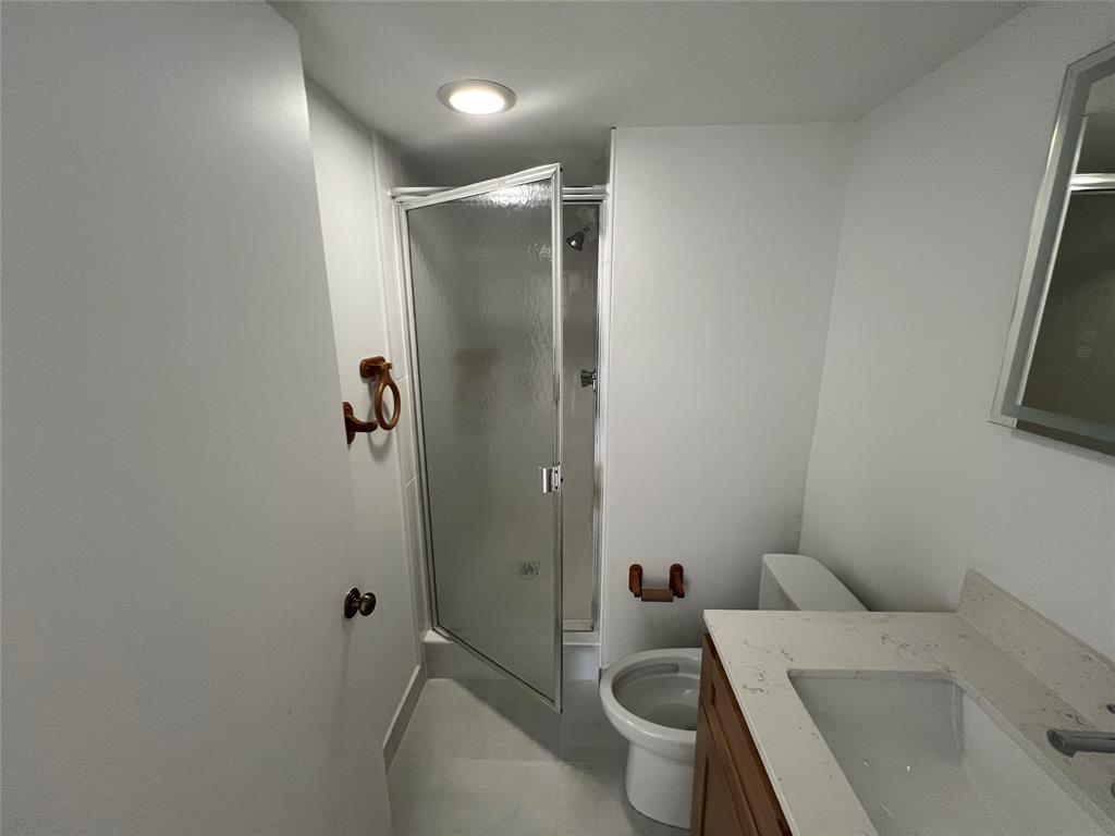 9300 Southwest 8th Street, Unit 422 Boca Raton, FL 33428 - Photo 37 of 38 a bathroom with a sink toilet and shower